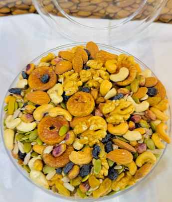 Mix of dried fruits in a bowl: apricot slices, raisins, cashews, and mixed pieces